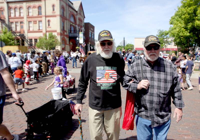 Ray Rickman of Lake Geneva, right, escorts Al Frank, 97, of Bull Valley during a Memorial Day parade in downtown Woodstock on Monday, May 26, 2025. Rickman served with the Air Force during three tours in Vietnam between 1969-1973 and Frank served in the Army during World War Two.