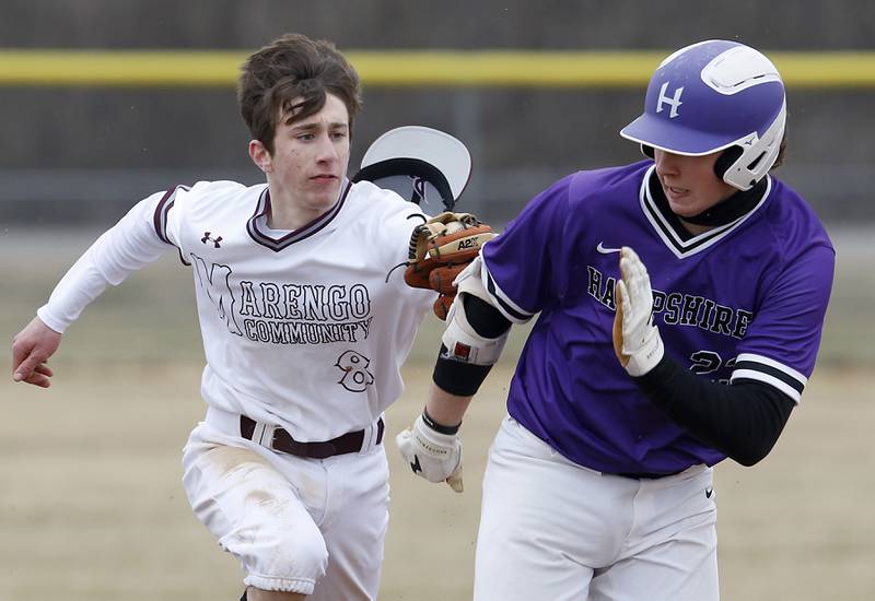 Marengo's Patrick Signore tags out Hampshire's Dominick Kooistra as Kooistra got caught between first and second bases while trying to steal second base during a non-conference baseball game Wednesday, March 30, 2022, between Marengo and Hampshire at Marengo High School.