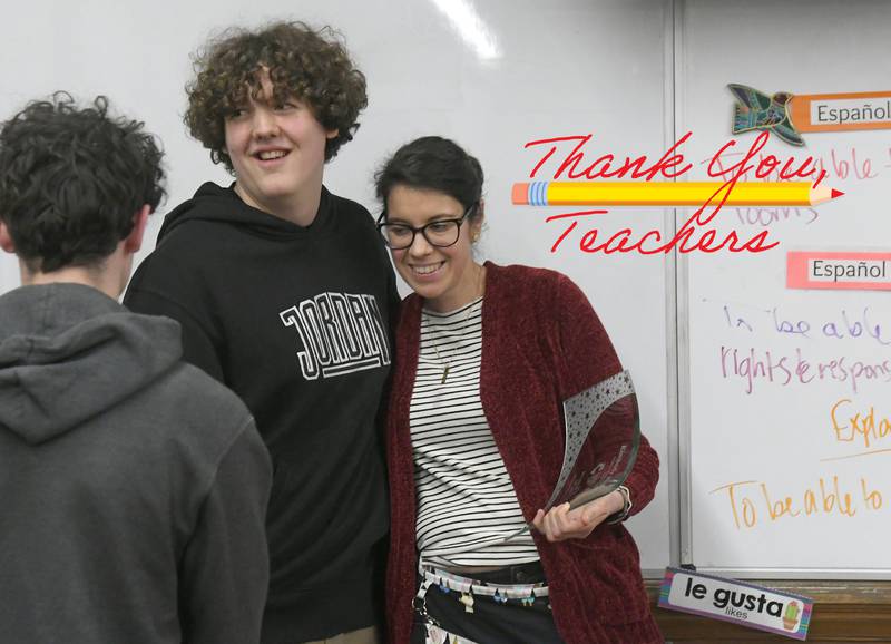 Oregon High School teacher Kimberly Radostits gets a hug from one of her students, Andru Holland-Jones after receiving the award for being chosen 2022 Illinois Teacher of the Year. Officials surprised Radostits with the announcement in her classroom on Tuesday morning.