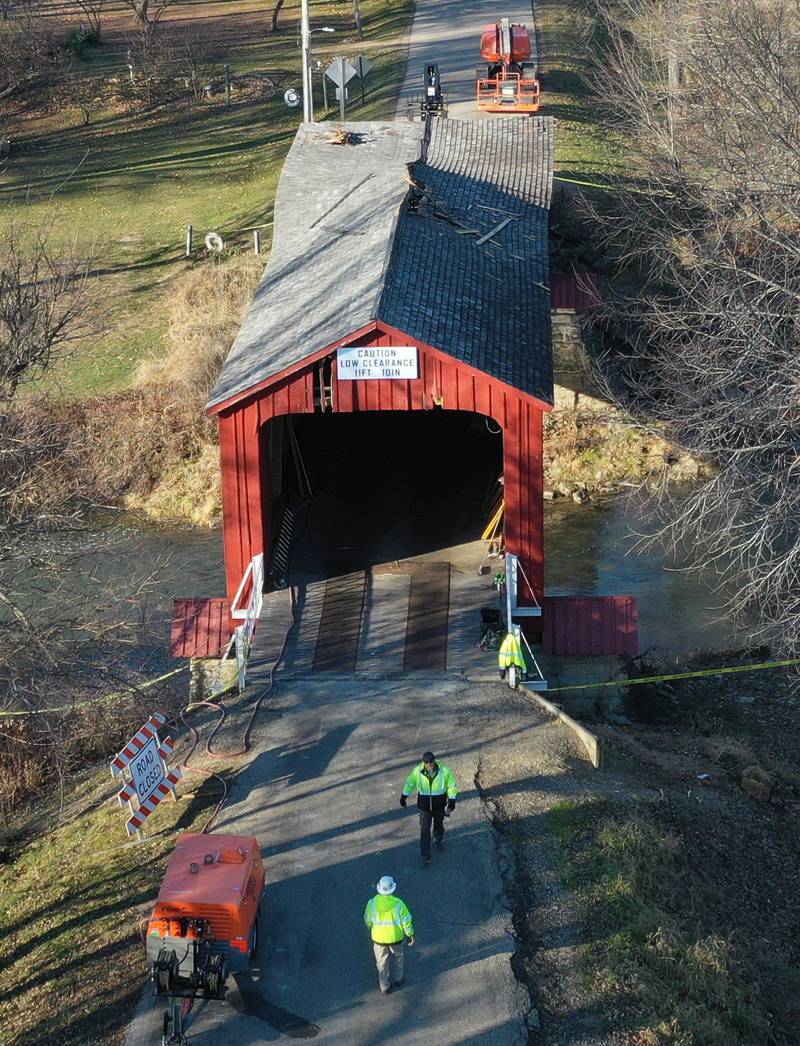 An Illinois Department of Transportation crew begins repairs on the Red Covered Bridge on Monday, Dec. 11, 2023 in Princeton. The bridge was severely damaged when it was struck by a semi truck on Nov. 16.