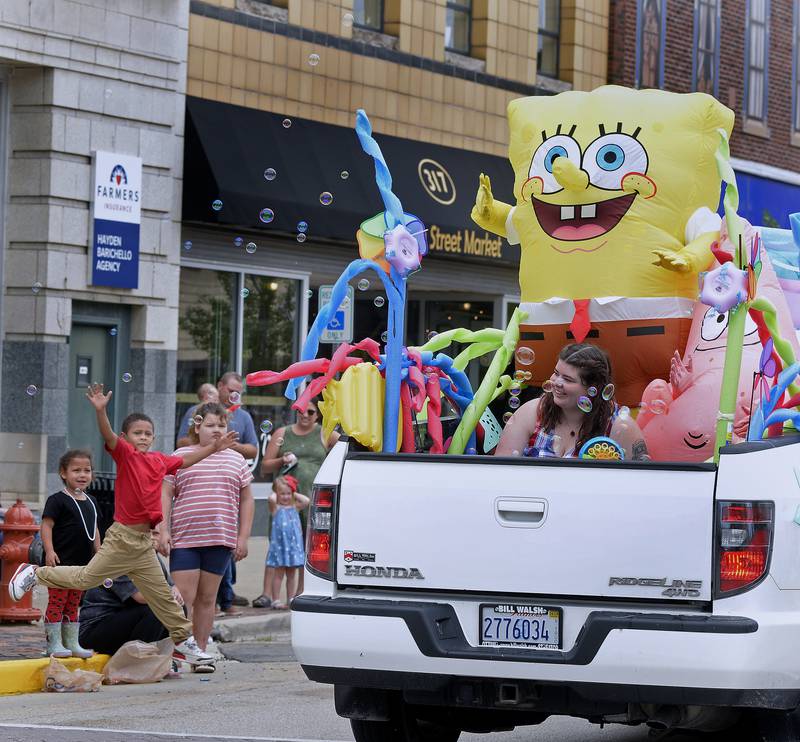 SpongeBob SquarePants waves the crowd from the Light up Streator parade Sunday, July 2, 2023, during the Streator Independence Day parade in the city's downtown.
