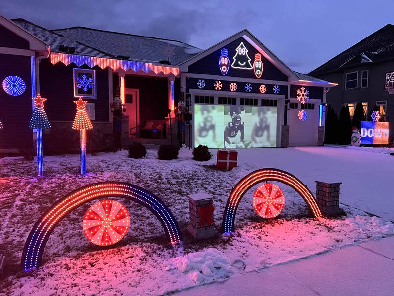 Chicago Bears highlights play on the garage door during light show put together by Tim Caravia and his family Friday, Jan. 16, 2025, at his home on Dustin Drive in Sycamore. The show will run from 5:30 to 9:00 p.m. most days until the Bears season ends.