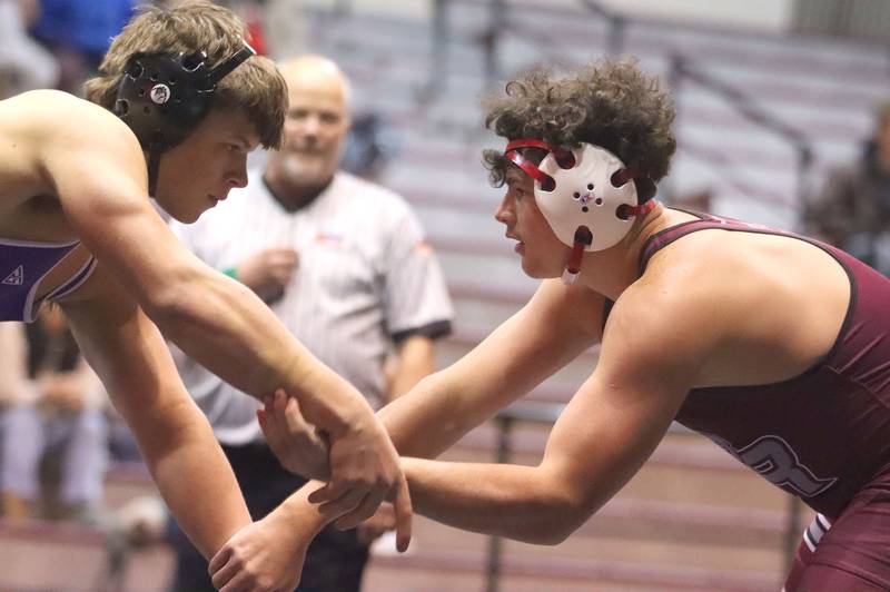 Prairie Ridge’s Frank Matviychuk, right, battles Hampshire’s Knox Homola at 215 pounds in varsity boys wrestling on Thursday, Dec. 4, 2025, at  Prairie Ridge High School in Crystal Lake.
