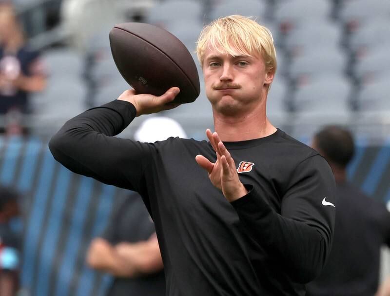 Former Northern Illinois University and current Cincinnati Bengals quarterback Rocky Lombardi loosens up before making his NFL debut Saturday, Aug. 17, 2024, at Soldier Field in Chicago. Lombardi checked in during the second half of a 27-3 loss to the Chicago Bears. Lombardi is competing for a roster spot with the Bengals.