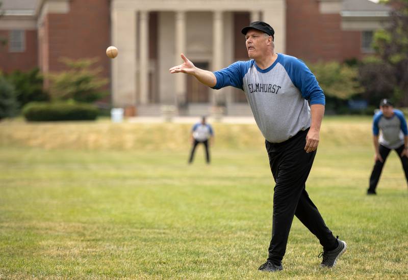 Elmhurst University President Troy VanAken pitches in the first inning of the Elmhurst Heritage Foundation's Vintage Baseball Game at Elmhurst University Mall on Sunday, June 4, 2023. Both teams from the city of Elmhurst and Elmhurst University played with baseball rules from 1850.