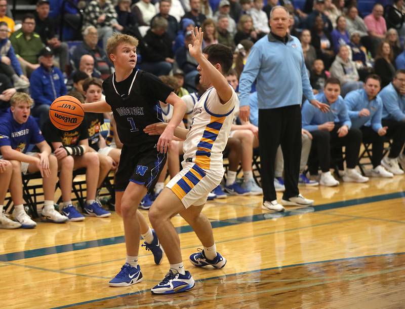 Woodstock's Rian Hahn Clifton brings tries to drive the baseline against Johnsburg's Ryan Franze during a Kishwaukee River Conference boys basketball game on Friday, February. 13, 2026, at Johnsburg High School.
