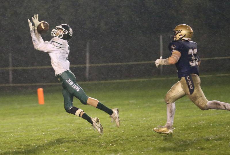 St. Bede's Hunter Savage makes a leaping catch over Marquette's Grant Dose on Friday, Oct. 13, 2023 at Gould Stadium.