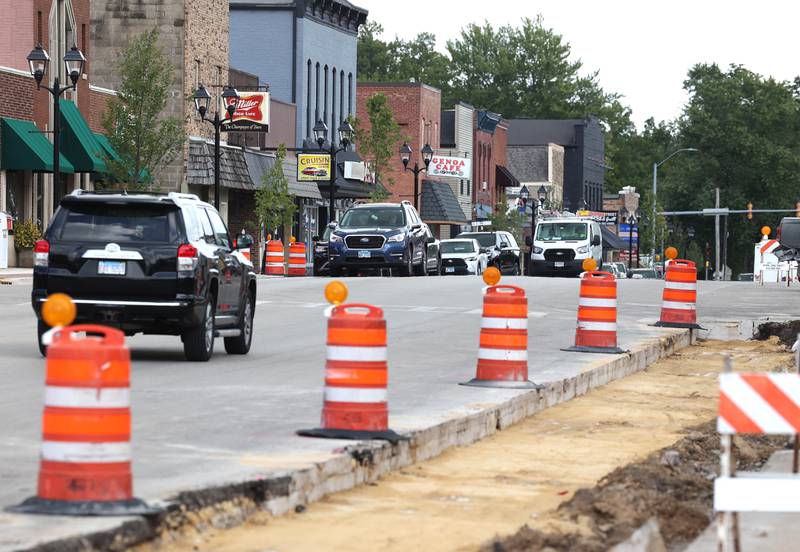 Cars pass by the sidewalk construction Wednesday, Aug. 28, 2024, on Main Street in Genoa.