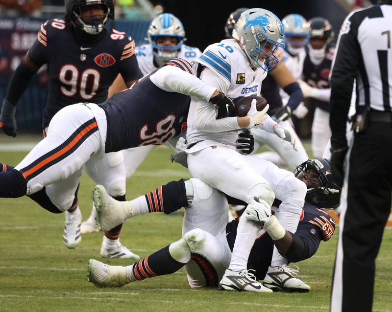 Chicago Bears defensive end Montez Sweat (left) and defensive end Grady Jarrett sack Detroit Lions quarterback Jared Goff during their game Sunday, Jan. 4, 2026, at Soldier Field in Chicago.