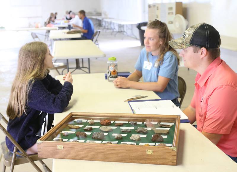 Audra Wasilewski of Sheffield has her rock collection judged by Lorraine Folske and Aaron Fishbum during the Bureau County 4-H Fair on Thursday, July 13, 2023 in Princeton.
