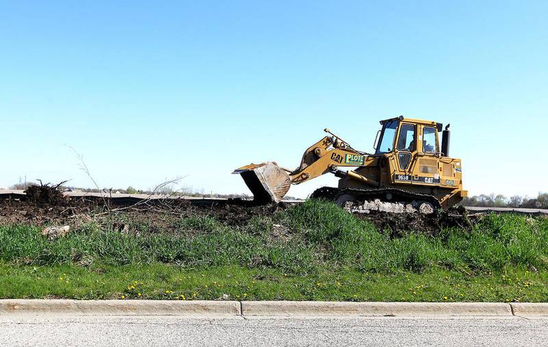 A worker from Plote Construction grades the right of way Monday, April 17, 2017 on the north side of Longmeadow Parkway east of Stonegate in Algonquin. Pavement removal and widening work started in sections including about 1,500 feet north and south of Randall Road and Longmeadow Parkway; north and south of Sleepy Hollow Road and Longmeadow Parkway; and on Longmeadow Parkway from Randall Road to east of White Chapel Drive.