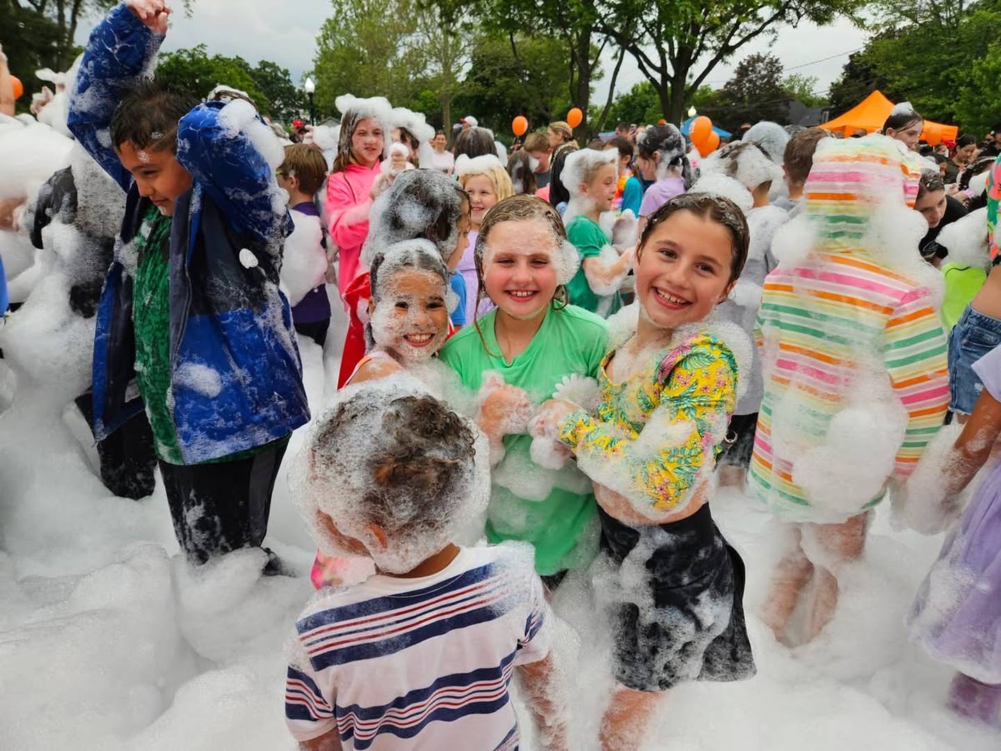 Dancing and laughing in the foam pit, children soak up the first rays of summer at Yorkville's "School's Out Beach Party."