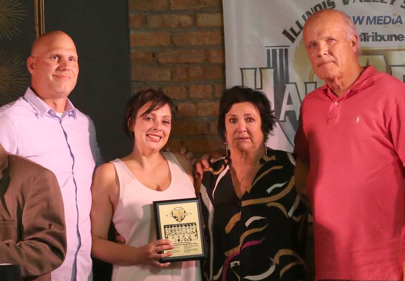 (From left) Adam Curran, Maria Baird, and parents Lorna mom Rich accept the 1997-98 Hall Boys Basketball Team award during the 2025 Shaw Media Illinois Valley Sports Hall of Fame at the Auditorium Ballroom in La Salle. Derek Baird, a member on the team passed away in 2024 from cancer. The Baird's accepted the award in his honor.