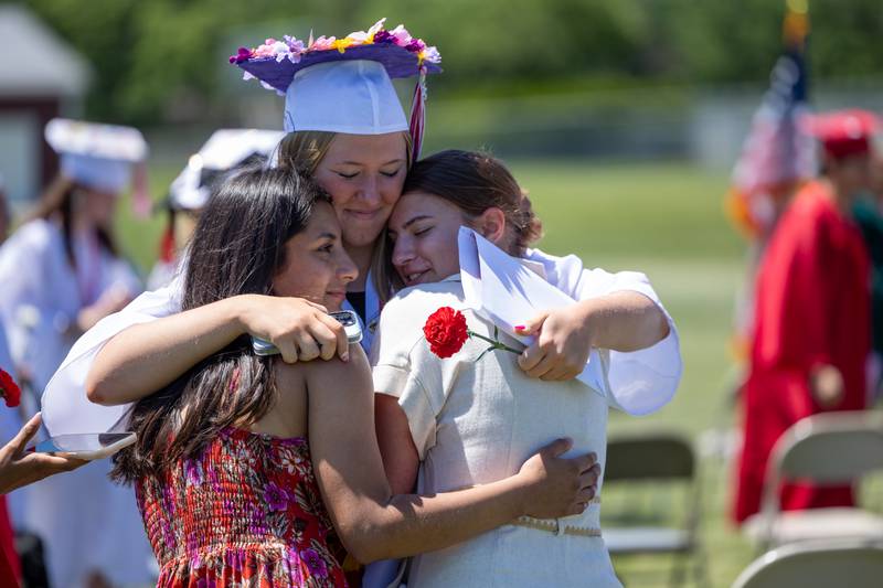 Ella Sterling embraces friends after graduating on Sunday, May 18, 2025 at Hall High School in Spring Valley.