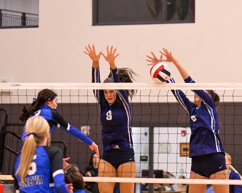 Nazareth Academy’s Grace Gravante, right, blocks the ball while teammate Jane Manecke, center, helps block while Geneva's Zoriana Malone (13) spikes the ball during the sectional title game on Thursday Nov. 6, 2025, held at Timothy Christian High School.