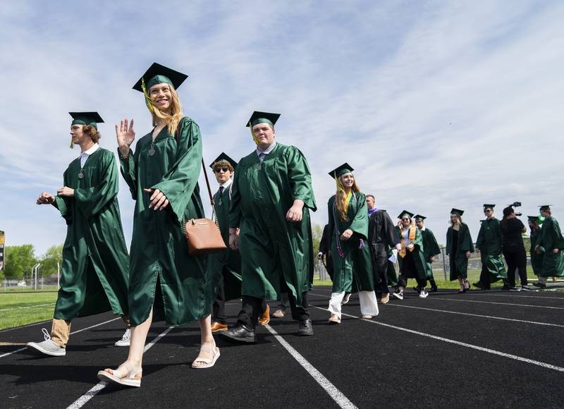 Graduates march onto the football field during a graduation ceremony for the class of 2022 on Saturday, May 14, 2022, at Crystal Lake South High School in Crystal Lake.