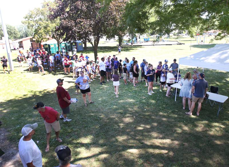 Over a hundred people wait in line for an autograph and a photo with J.A. Happ during the J.A. Happ Day and field dedication on Sunday, July 30, 2023 at Washington Park in Peru.