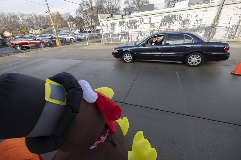 A happy patron waves as he heads off with a hot meal Thursday, Nov. 24, 2022 in Dixon.