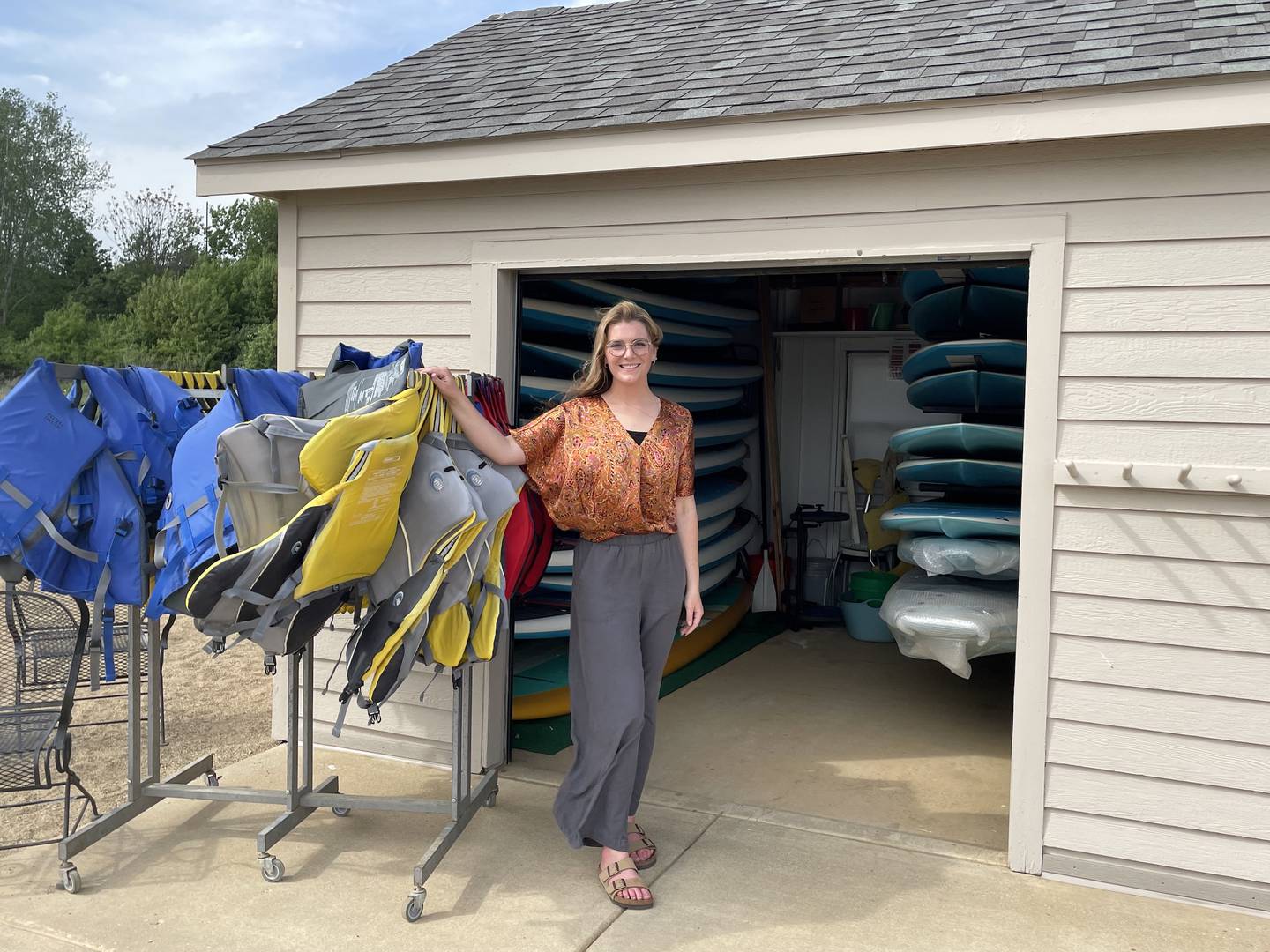 McKenna Dunn prepares to open The Board House at Three Oaks Recreation Area on Saturday, May 24. She and her father, James Dunn, are the new co-owners of the stand-up paddleboard rental and lessons shop at the popular Crystal Lake destination.