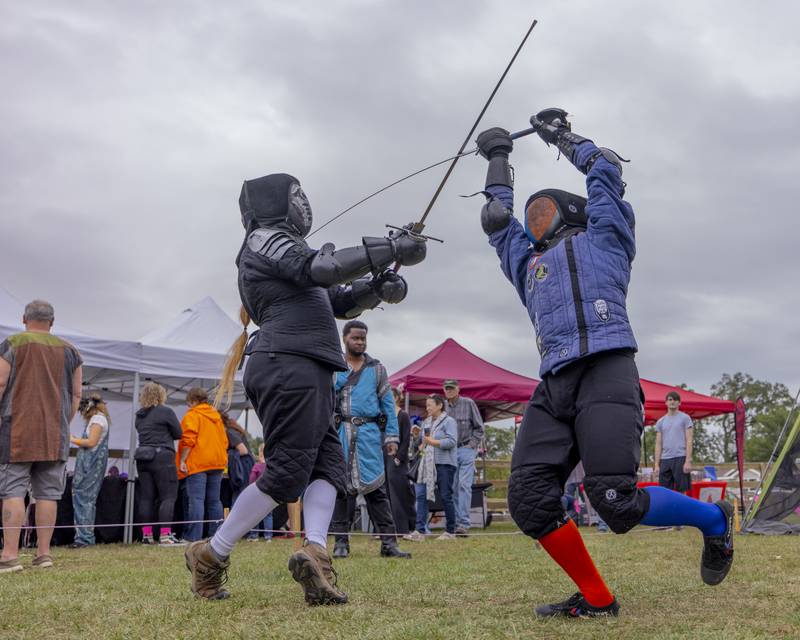 Sean Thummachart (right) scores a touch on Erik Archer (left) with his early rapier to score a point Saturday, Sept. 28, 2024, during a live combat demonstration at the Cedar Creek Ranch Renaissance Faire.
