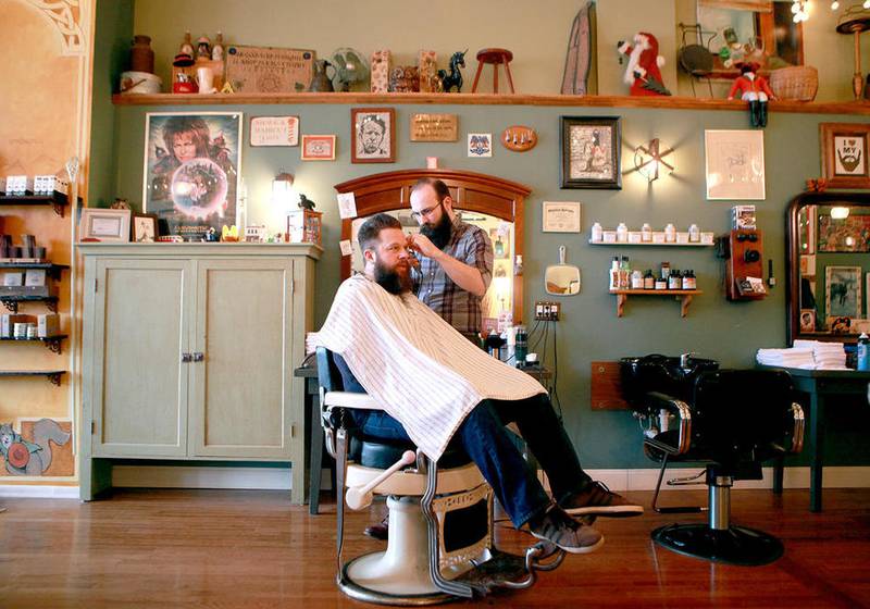 Co-owner and barber Tyler Anderson works with client Brandon Crawford of North Aurora at Beardsgaard Barbers in Batavia.