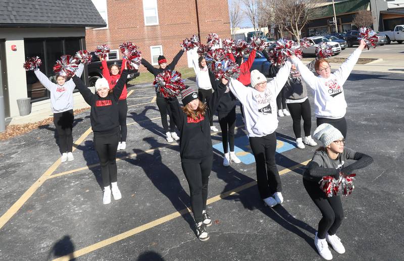 Earlville Jr. High cheerleaders perform a routine during the annual Freezin' for a Reezin' event on Friday, Dec. 6, at the corner of La Salle and Lafayette Street downtown Ottawa. The all-day event to helps the Ottawa Community Food Basket.