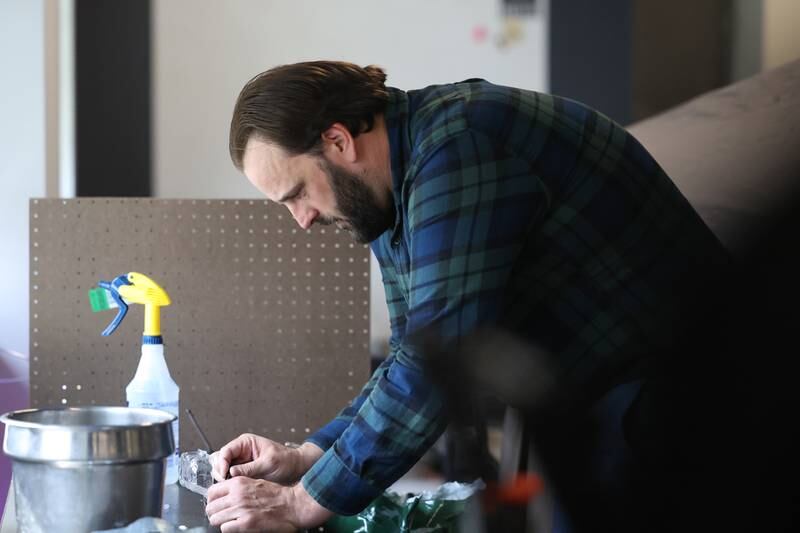 Jake Ziesmer, a teacher at Joliet Catholic Academy, makes preparations for a class project on Monday, April 24, 2023 in Joliet.