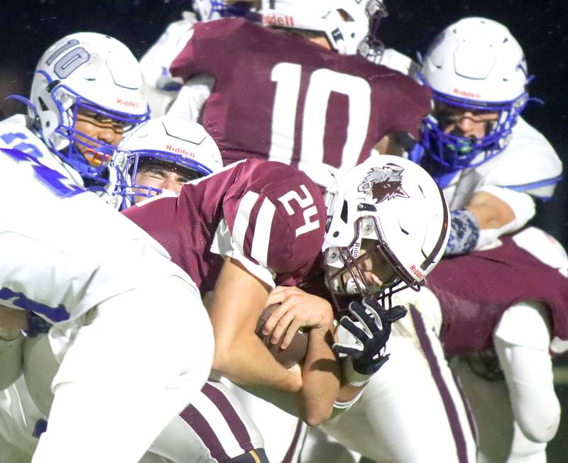 Prairie Ridge’s Vincent Byk runs the ball through a pack of Vernon Hills Cougars in IHSA football Class 5A first-round playoff action at Prairie Ridge High School in Crystal Lake on Friday, October 31, 2025.