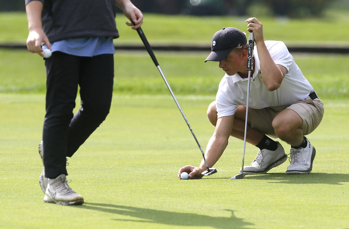 Prairie Ridge’s Charlie Pettrone lines up his putt on the seventh green during the Fox Valley Conference Boys Golf Tournament Thursday, Sept. 21, 2023, at McHenry Country Club in McHenry.