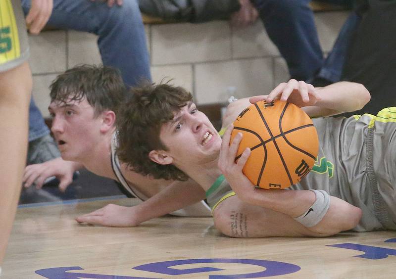 Seneca's Sebastian Deering falls on a loose ball as Marquette's Griffin Dobberstein dives in late on Friday, Feb. 21, 2025 in Bader Gym at Marquette Academy.