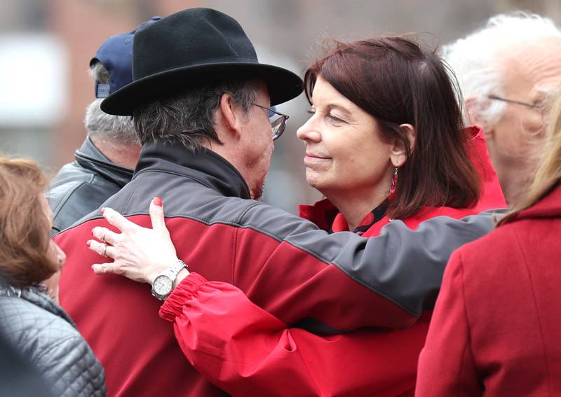 Joe Dubowski, (left) father of shooting victim Gayle Dubowski, greets Lisa Freeman, president of Northern Illinois University, during a remembrance ceremony Tuesday, Feb. 14, 2023, at the memorial outside Cole Hall at NIU for the victims of the mass shooting in 2008. Tuesday marked the 15th year since the deadly shooting took place on campus which took the lives of five people.