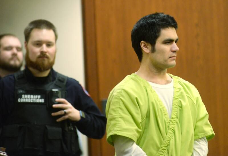 Jonathon Gounaris (right) is escorted into an Ogle County courtroom at the Judicial Center in Oregon on Thursday, Jan. 23, 2025. He is charged with the attempted murder of three law enforcement officers during a standoff at his rural Dixon home in June 2024 and is being held in the Winnebago County Jail as his case proceeds through the court system.