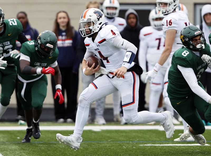 Oswego's Drew Kleinhans (4) runs with the ball during the varsity football second-round 8A playoff game between Oswego and Lane Tech on Saturday, Nov. 8, 2025 in Chicago.