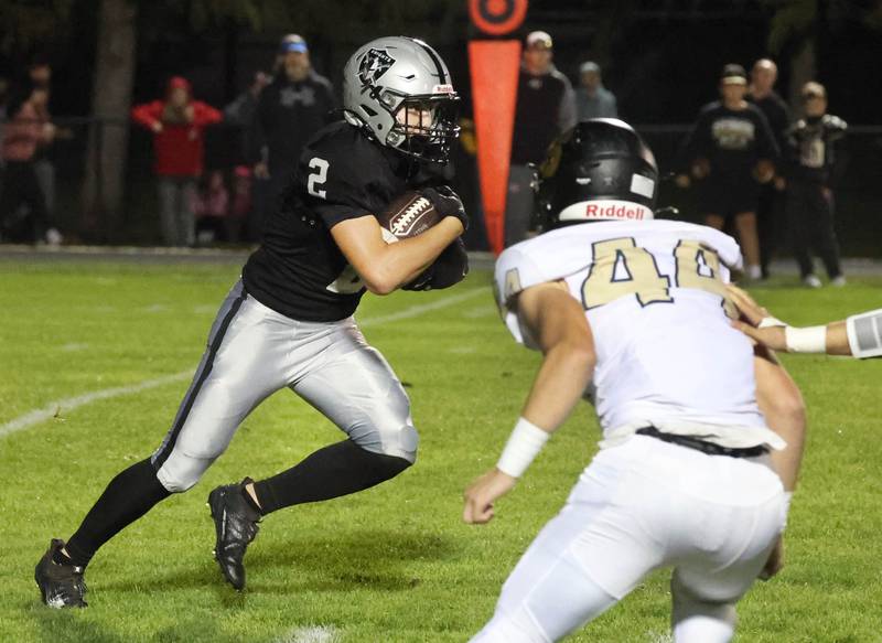 Kaneland's Dylan Sanagustin runs inside of Sycamore's Cooper Bode during their game Friday, Oct.4, 2024, at Kaneland High School in Maple Park.
