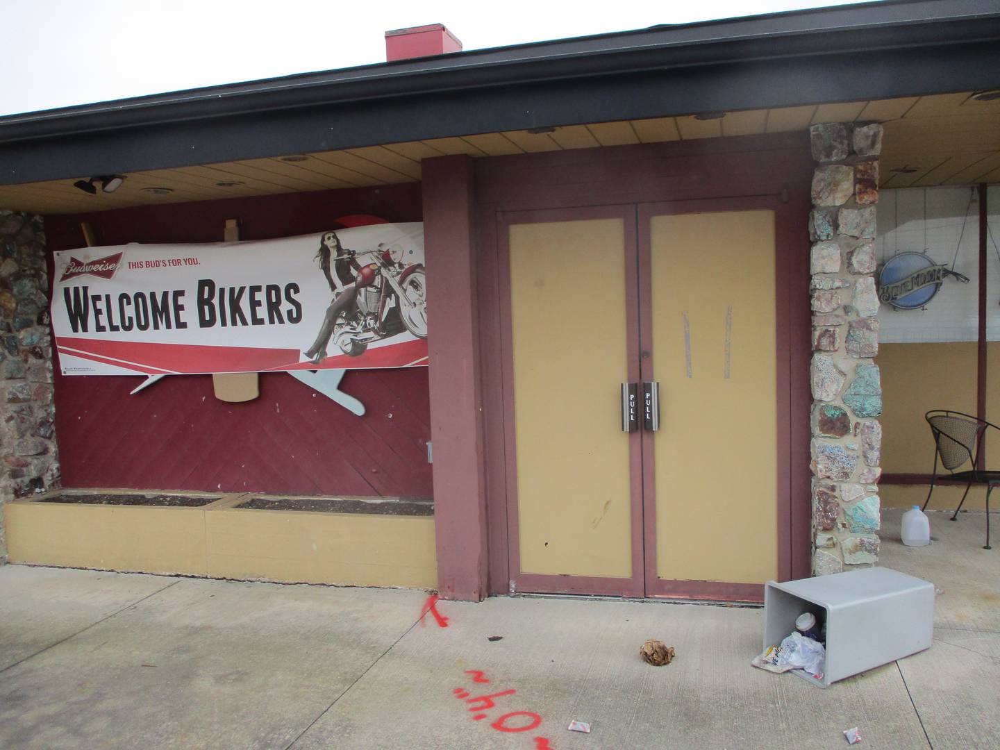 An overturned waste can stands outside the entrance of the restaurant and bar that appears to be no longer used at the Joliet Plaza Inn and Suites. March 5, 2024.