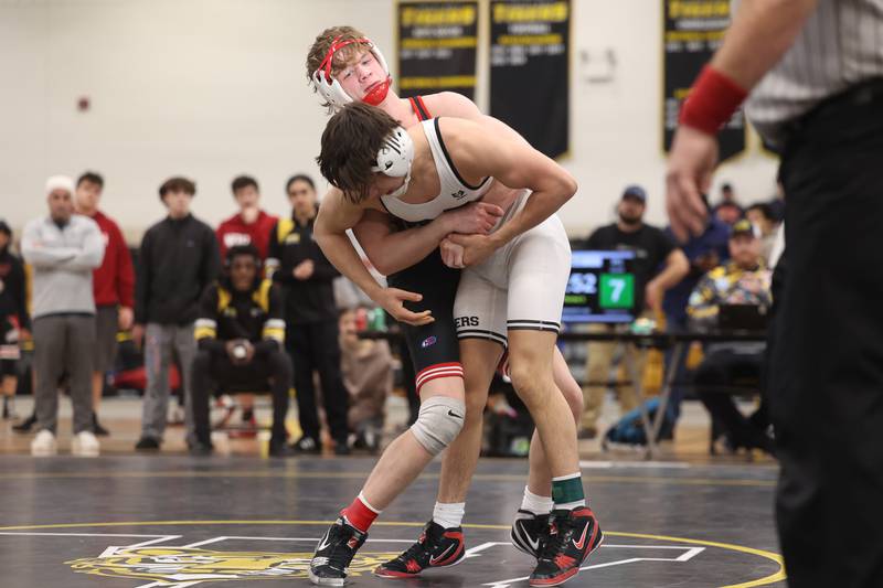 Yorkville’s Nathan Craft looks to throw Plainfield North’s Aidan Durell in the 126-pound weight SPC Conference championship match at Joliet West on Saturday, Jan 25, 2025.