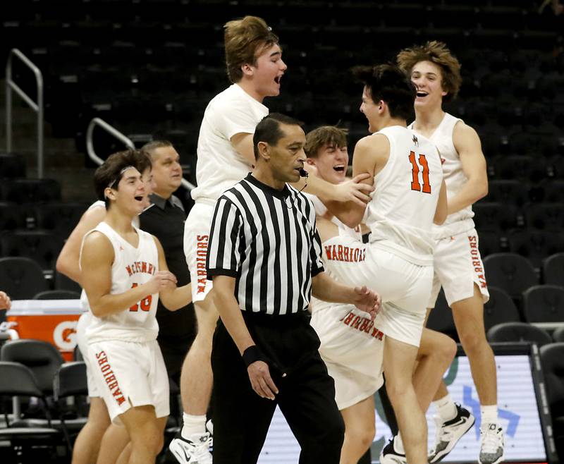 McHenry's Hayden Stone. #11, is created by his teammates after making a half court buzzer beater at the end of the third quarter as during a non-conference basketball game Sunday, Nov. 27, 2022, between Johnsburg and McHenry at Fiserv Forum in Milwaukee.