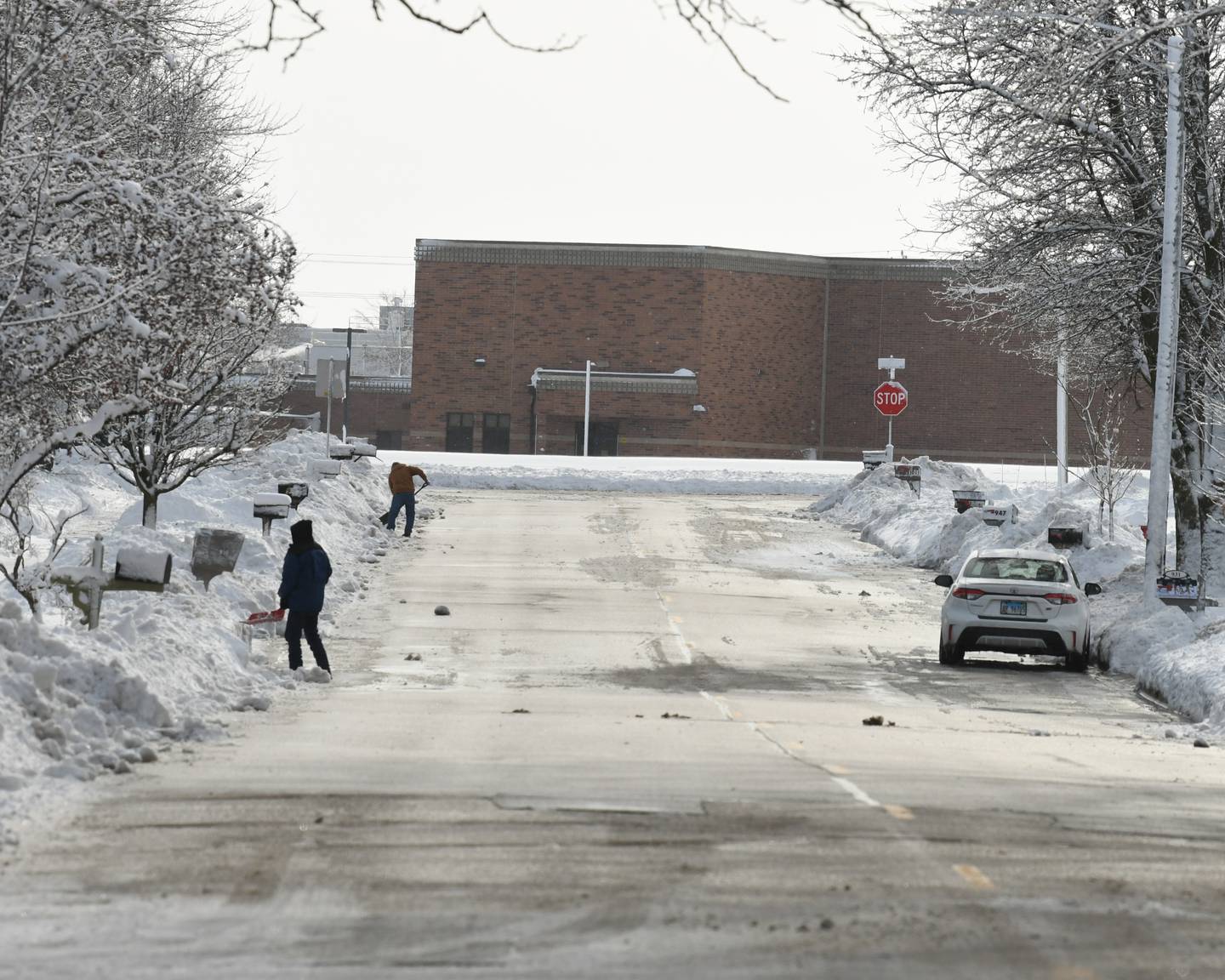 People on Meadow Lane in Sycamore remove snow from their driveways on Saturday Jan. 13, 2024, after heavy amount of snow fell on Friday.