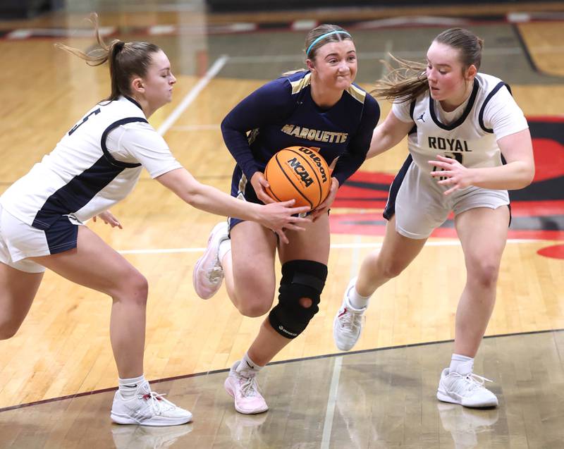 Marquette's Hunter Hopkins goes to the basket between two Rockford Christian defenders Tuesday, Feb 24, 2026, during their Class 1A sectional semifinal game at Indian Creek High School in Shabbona.