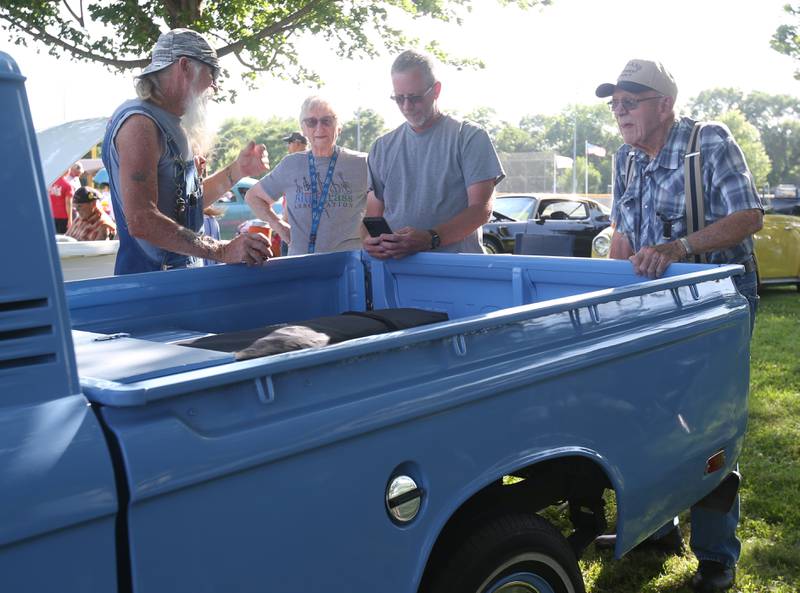Brian Woods, Claudia Seed, Dale Seed and William Seed chat about Dale's fully restored 1973 Chevy LUV pickup truck during the Utica Fire Department Car Show on Saturday, June 21, 2025 at Carey Memorial Park in Utica.