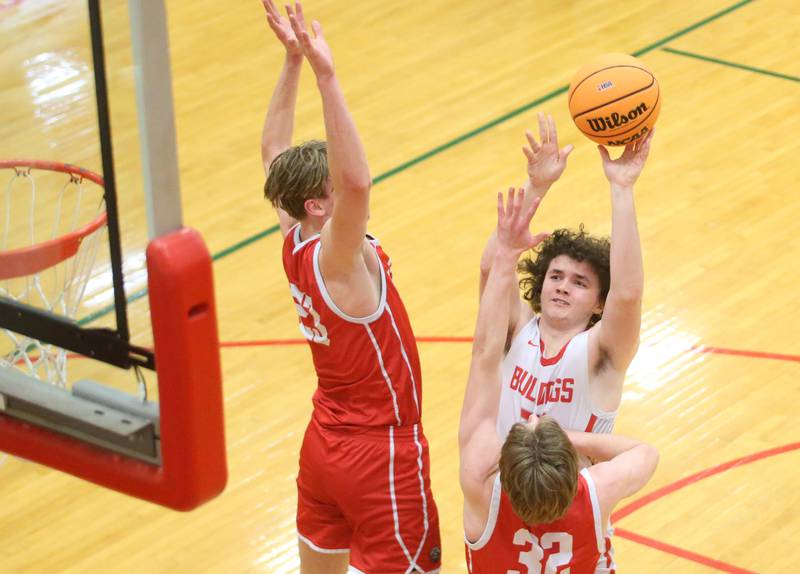 Streator's Joe Hoekstra lets go of a jump shot over Ottawa's Owen Sanders and Aric Threadgill during the Class 3A Regional semifinal game on Wednesday, Feb. 26, 2025 in Sellett Gymnasium at L-P High School.