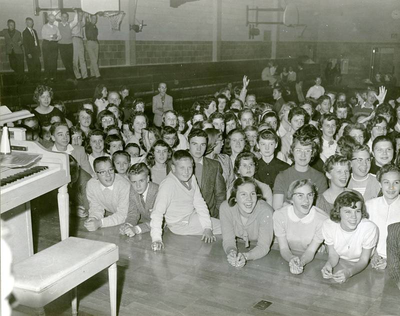 Students watch a show on the gymnasium stage of the DeKalb Junior High School, 1958-1959.