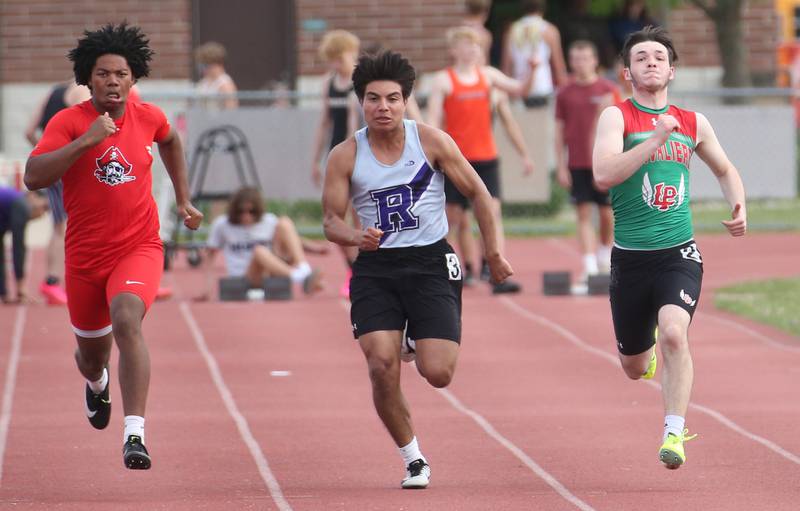 Ottawa's Colby Mortenson, Rochelle's Irving Escalante and L-P's Kaleb Kennedy compete in the 100 meter dash during the I-8 Boys Conference Championship track meet on Thursday, May 11, 2023 at the L-P Athletic Complex in La Salle.