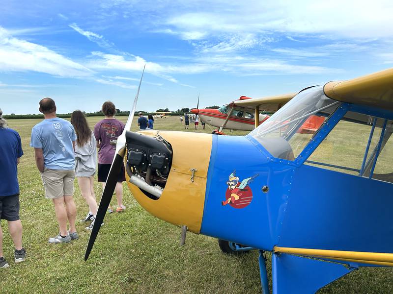 Visitors to the Ogle County Airport Fly in/Drive In Breakfast watch planes taxi to the grass runway on Friday, July 4, 2025. The airport is located at 3019 IL-64, just east of Mt Morris.