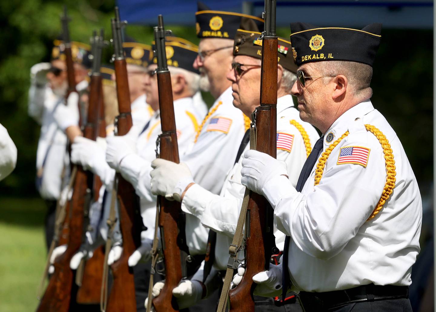 Members of the DeKalb American Legion Post 66 Honor Guard stand at attention Monday, May 26, 2025, during the Memorial Day ceremony at Ellwood House in DeKalb.