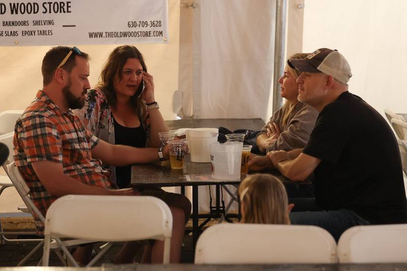 Eric Witry, left to right, Cathleen Lehocky, Holy Boyce and Chris Warpcan enjoy beer in the Beer Tent at the Saint Dennis and Joseph Catholic Academy Annual Oktoberfest on Saturday, Oct. 5, 2024 in Lockport.