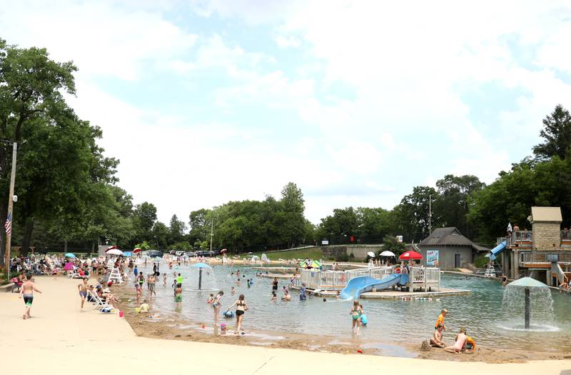 Patrons play in the water at the Batavia Park District’s Hall Quarry Beach on Thursday, June 13, 2024.