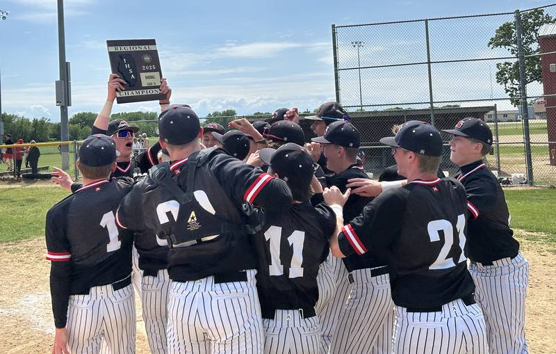 Fulton's Jacob Huisenga holds the regional trophy high in the air as he celebrates with his teammates following the Steamers' 7-4 win over Forreston at the 1A Amboy Regional on Saturday, May 24, 2025.