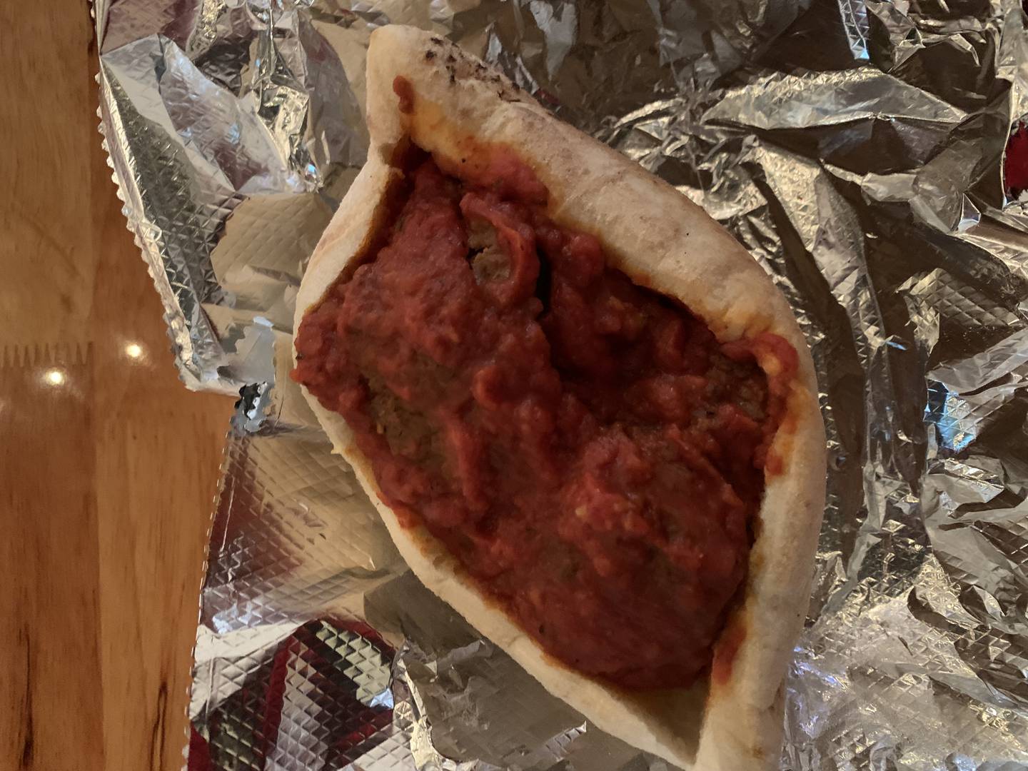 Your Sister's Tomato's meatball sandwich is wrapped in a house-made bread pocket that snuggled three meatballs.