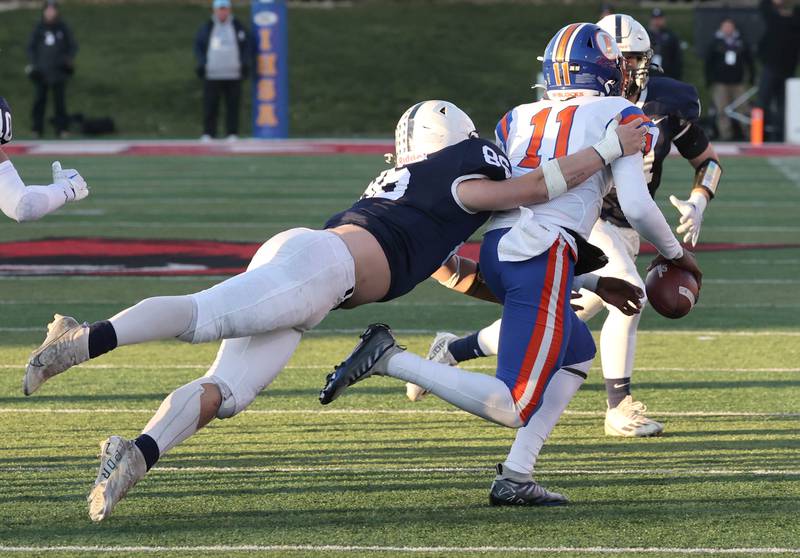 Cary-Groves Charles Ciske sacks East St. Louis' Reece Shanklin late in the game Saturday, Nov. 25, 2023, during the IHSA Class 6A state championship game in Hancock Stadium at Illinois State University in Normal.